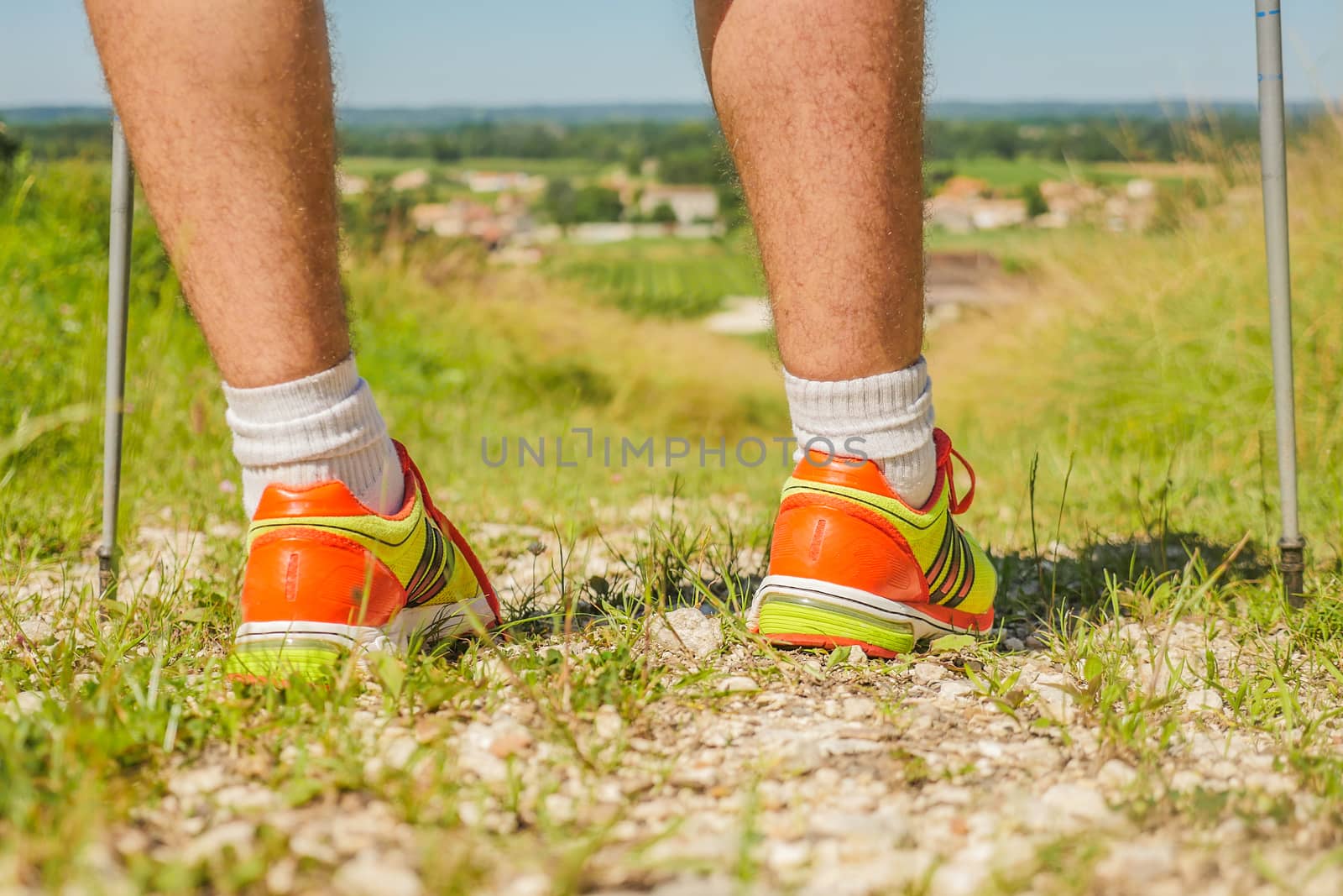 Man walking on sidewalk, sport shoes closeup, France