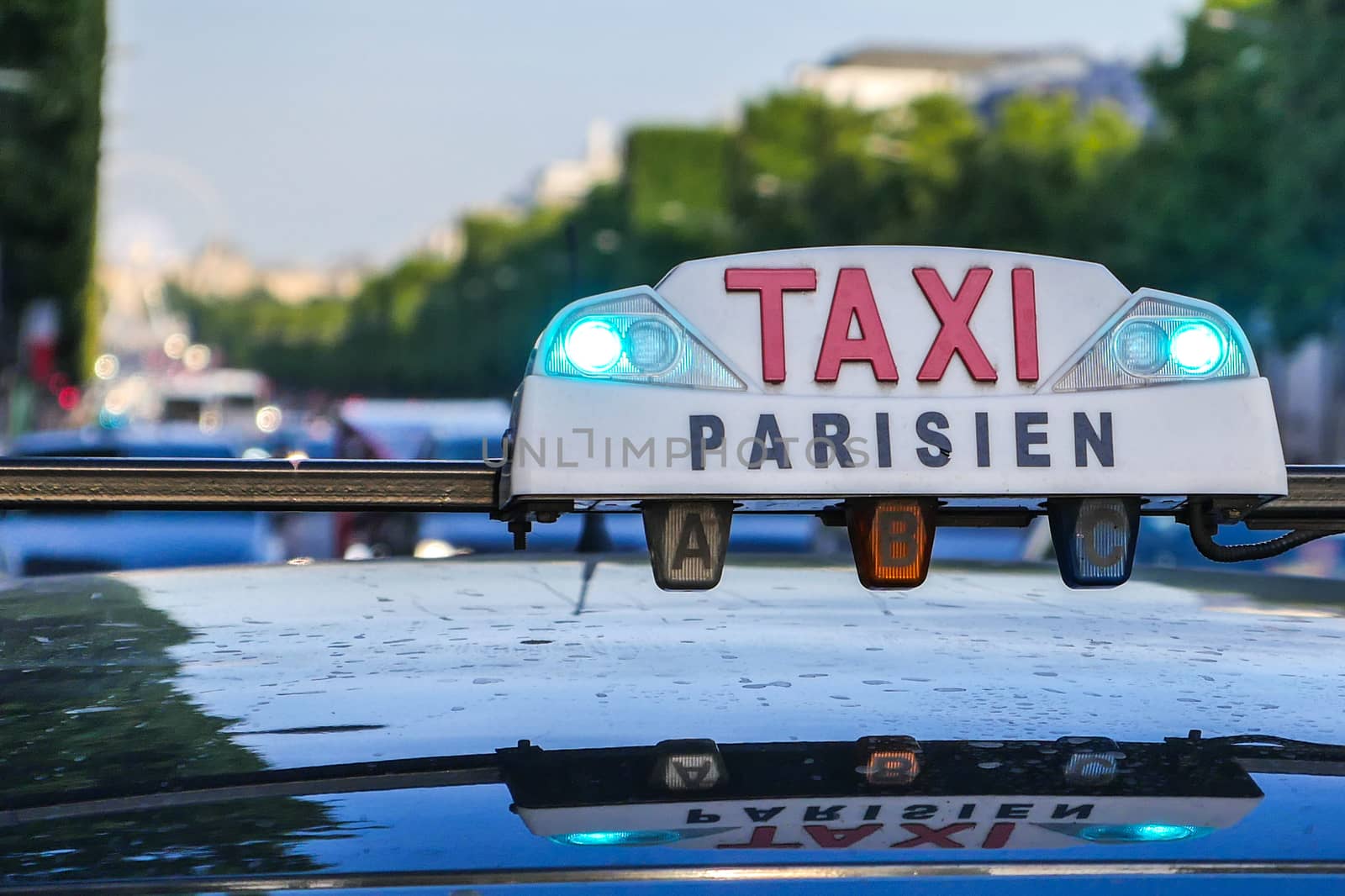 Paris taxi detail and Arc de Triomphe in the background, France