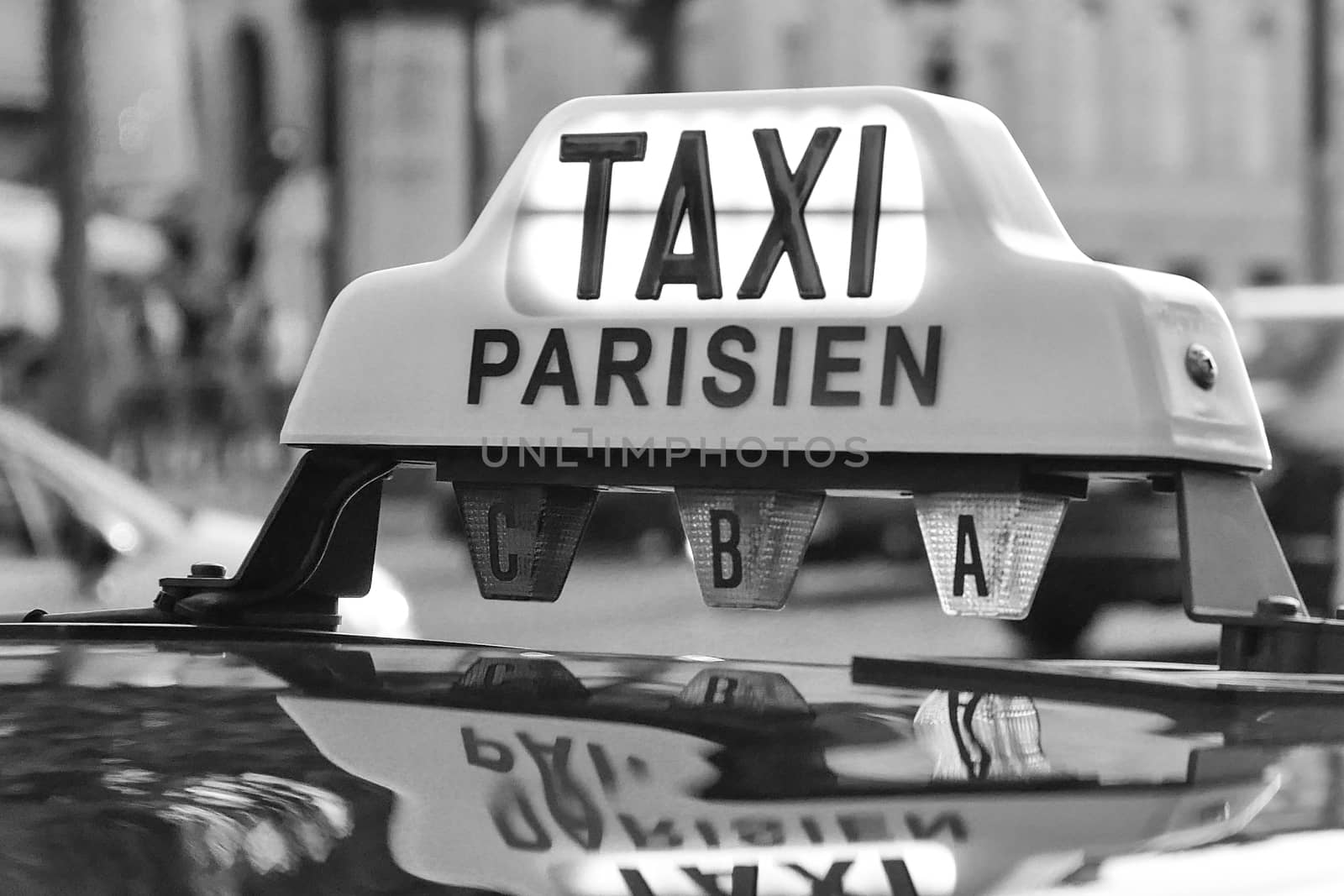 Paris taxi detail and Arc de Triomphe in the background, France