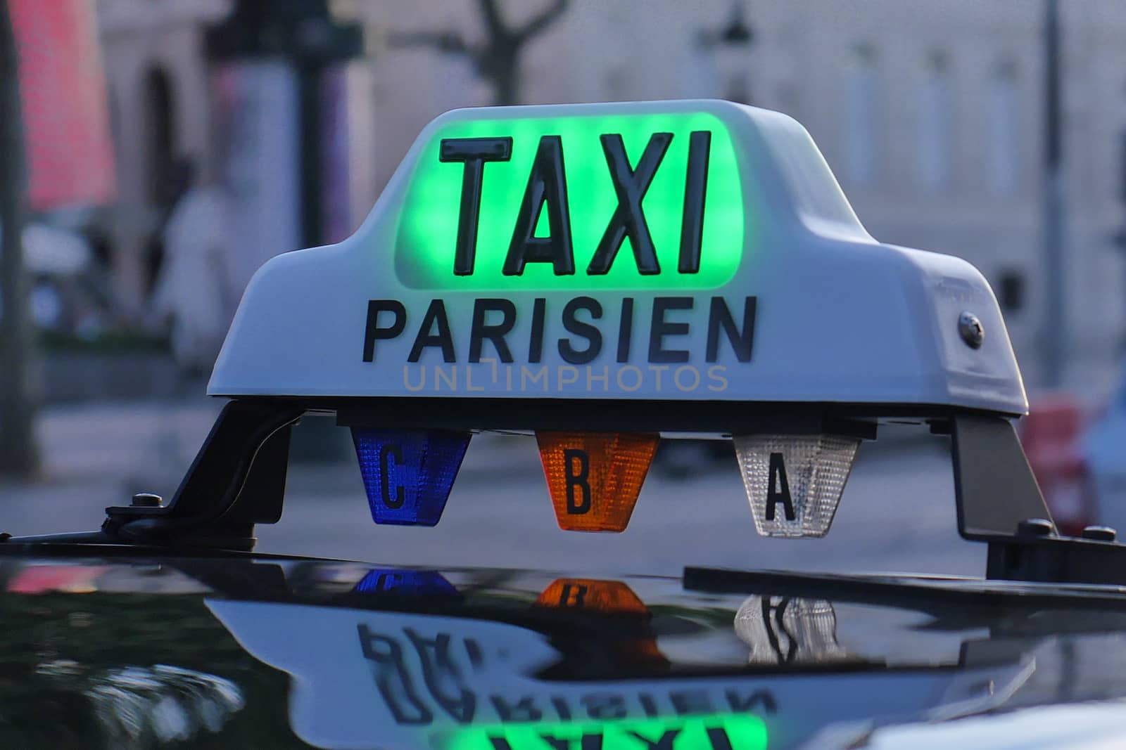 Paris taxi detail and Arc de Triomphe in the background, France