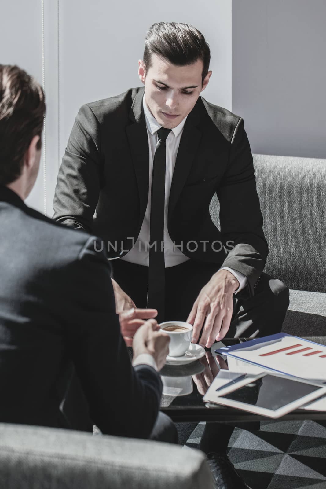 Two Business men having coffee break and talking at office