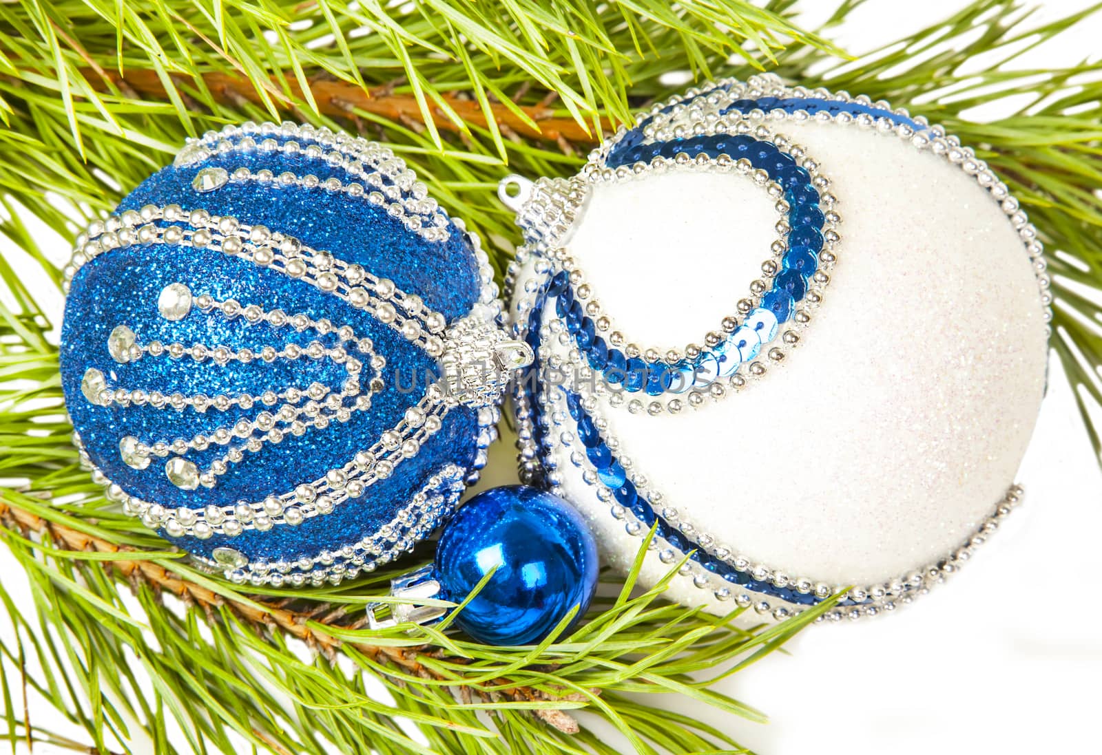 Christmas tree and blue ball with white glitter on white