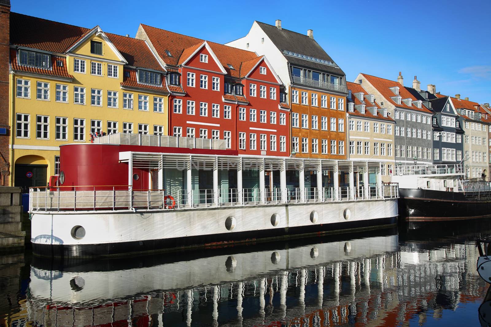 Yacht and color houses in seafront Nyhavn (new Harbor) in Copenhagen, Denmark