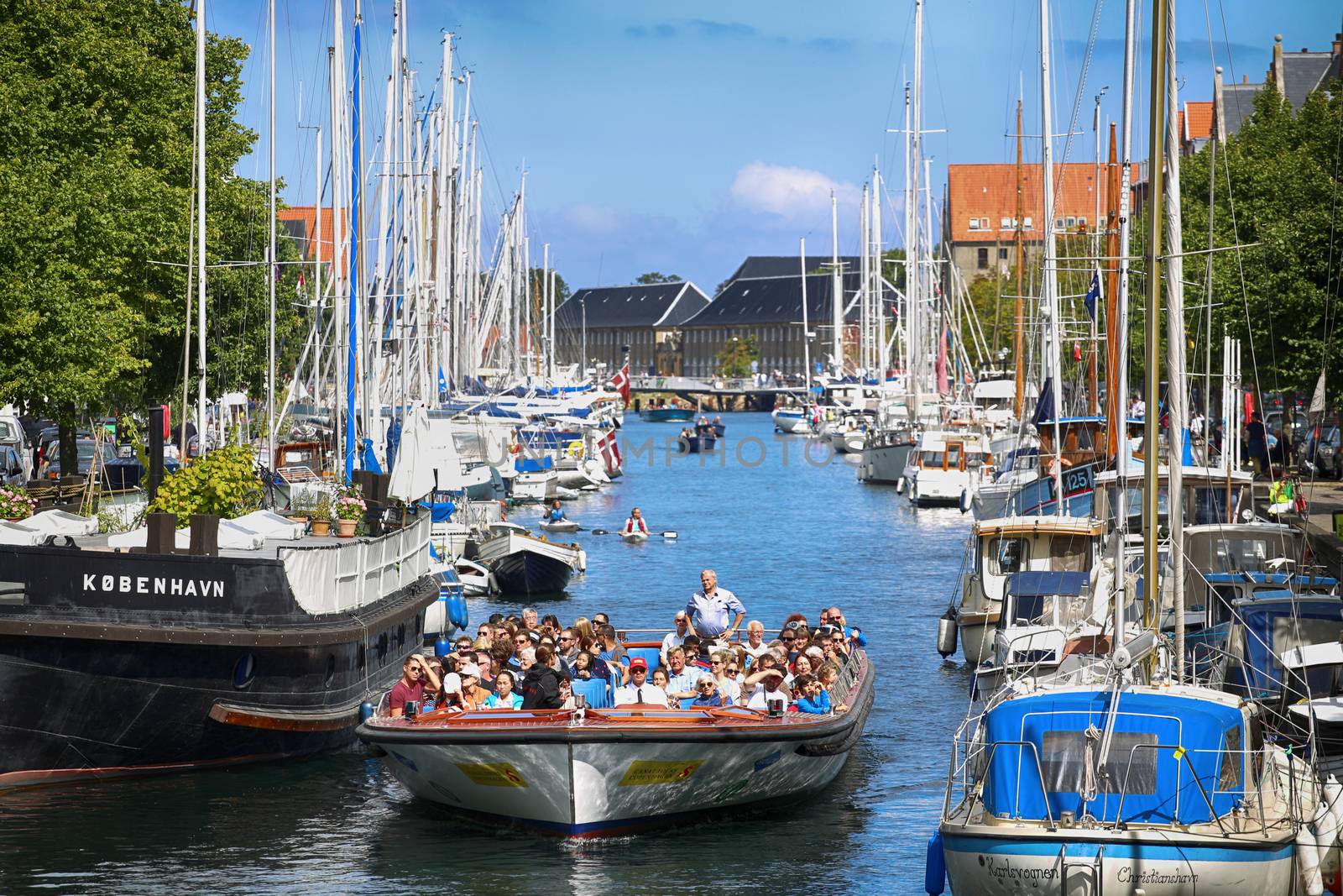 Copenhagen, Denmark – August 15, 2016: View on canal with tourist boat, beetwen Overgaden Oven Vandet street and Overgaden Neden Vandet street from bridge Sankt Anne Gade in Copenhagen, Denmark