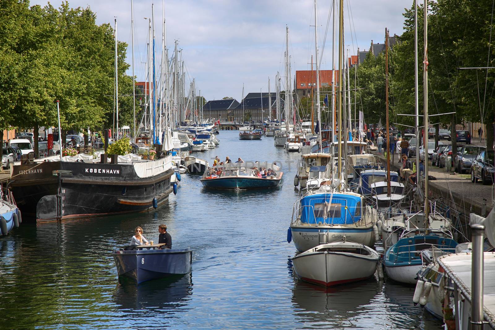 Copenhagen, Denmark – August 15, 2016: View on canal with tourist boat, beetwen Overgaden Oven Vandet street and Overgaden Neden Vandet street from bridge Sankt Anne Gade in Copenhagen, Denmark