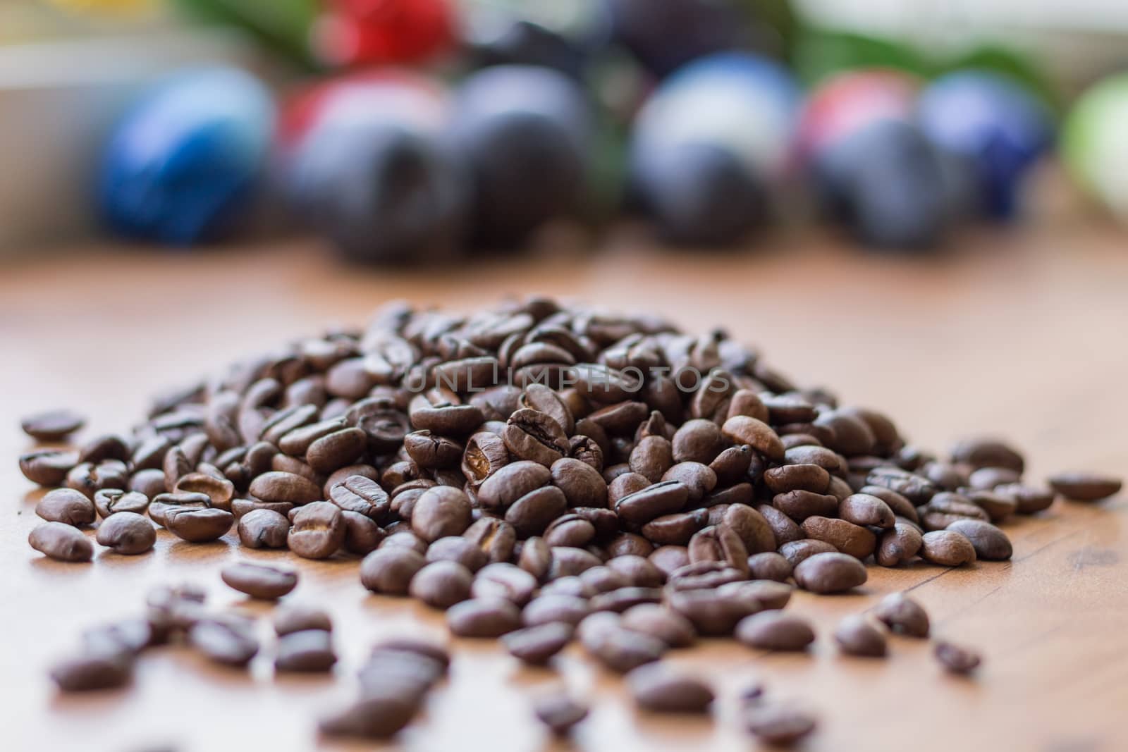 Small handful lot of brown roasted coffee beans