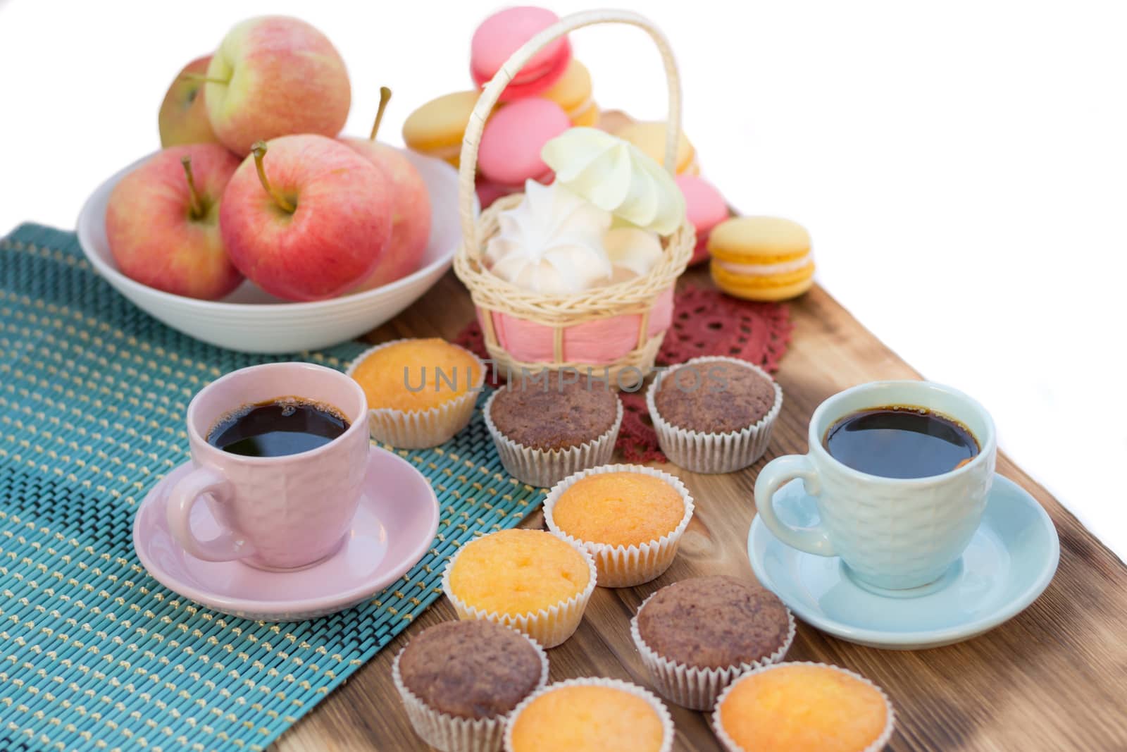 Still life of served coffee cups, macaroon cookies, marshmallows and apples