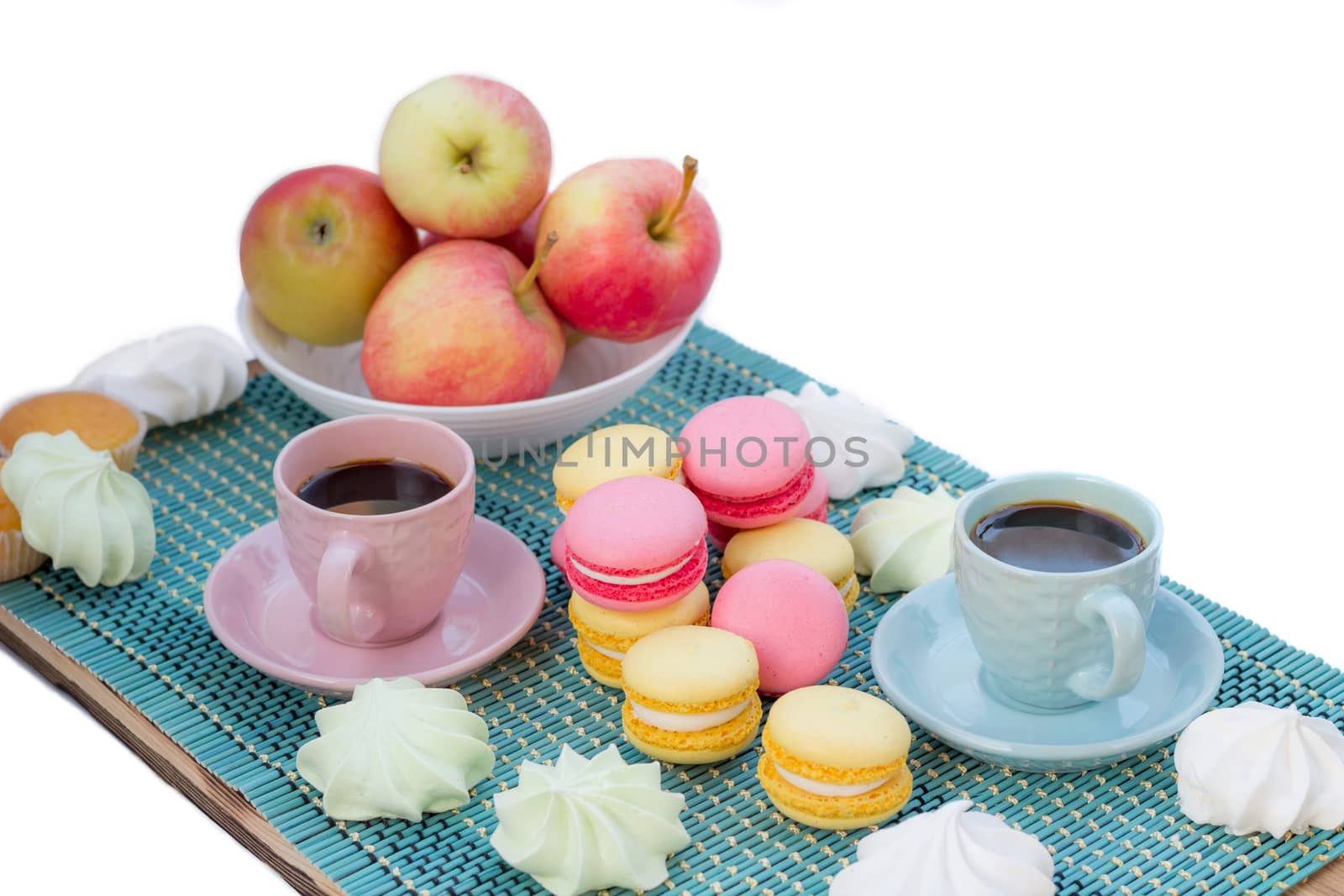 Still life of served coffee cups, macaroon cookies, marshmallows and apples