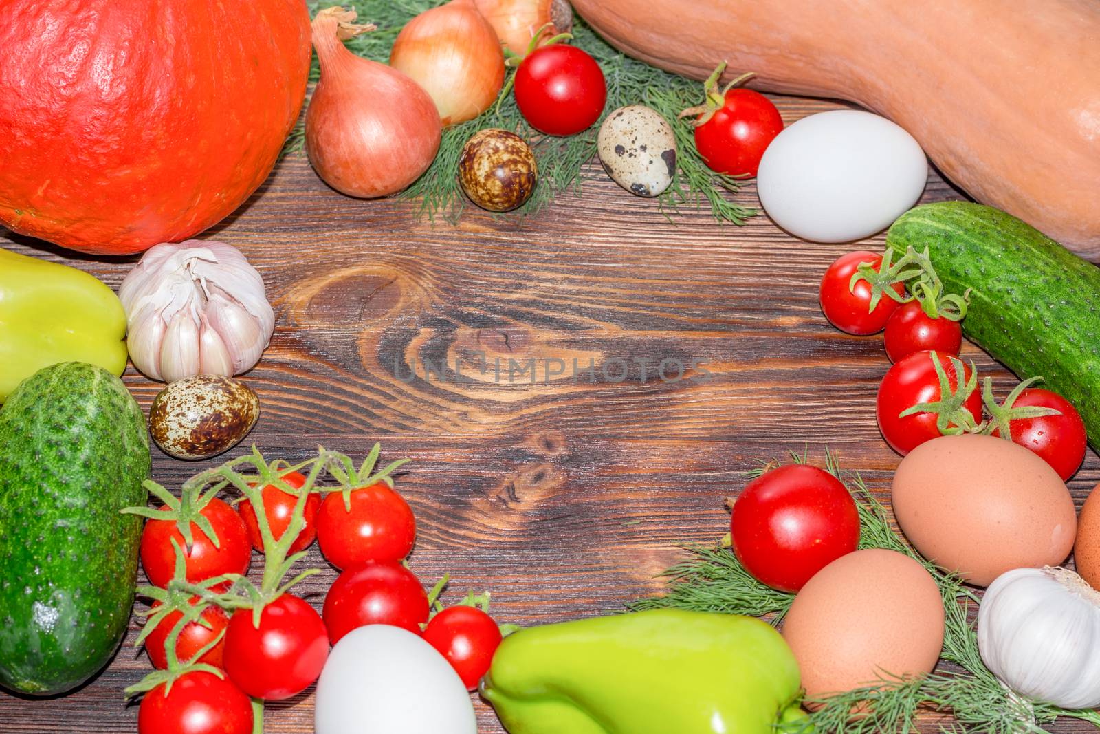 Bright Thanksgiving harvest composition of vegetables onions, cucumbers, peppers pumkin, calabash, tomatoes, garlic, eggs on dark wooden background