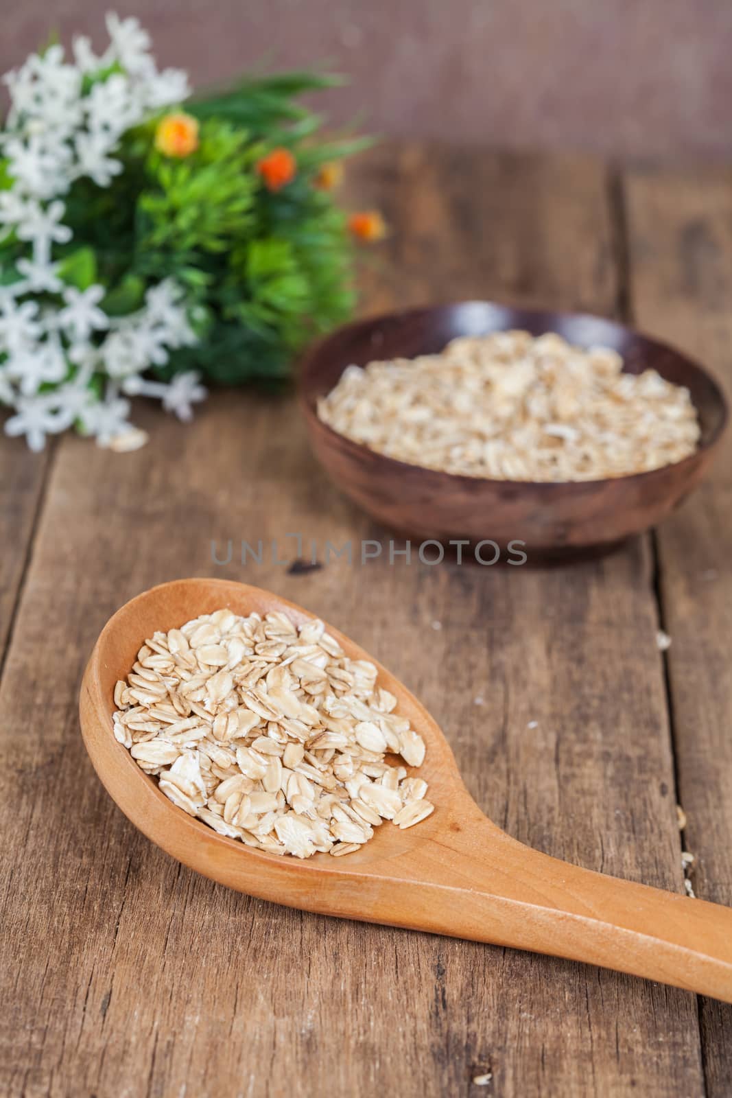 oats in spoon on wood table 