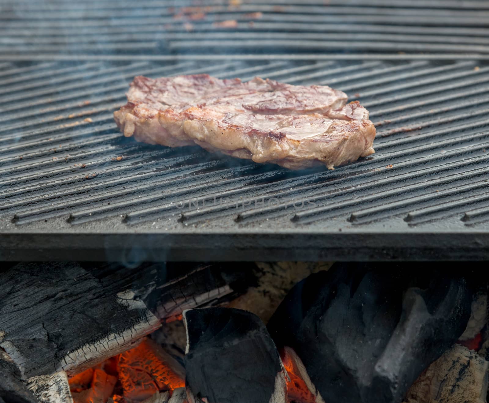 beef steaks on the grill by vlaru