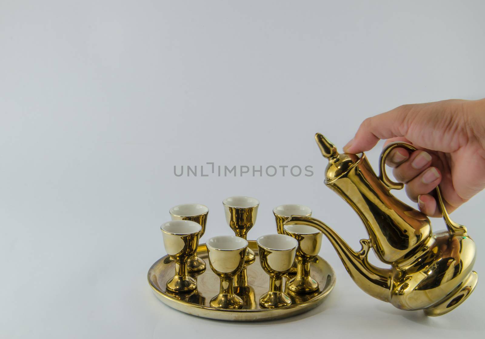 Gold jug Tea glass isolated on white background .