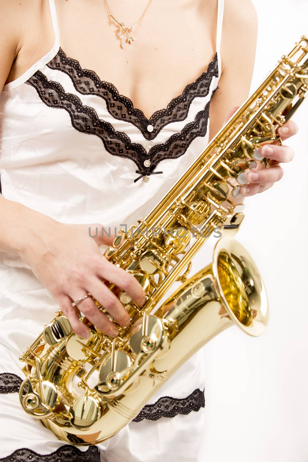 Sexy woman playing saxophone music on white background