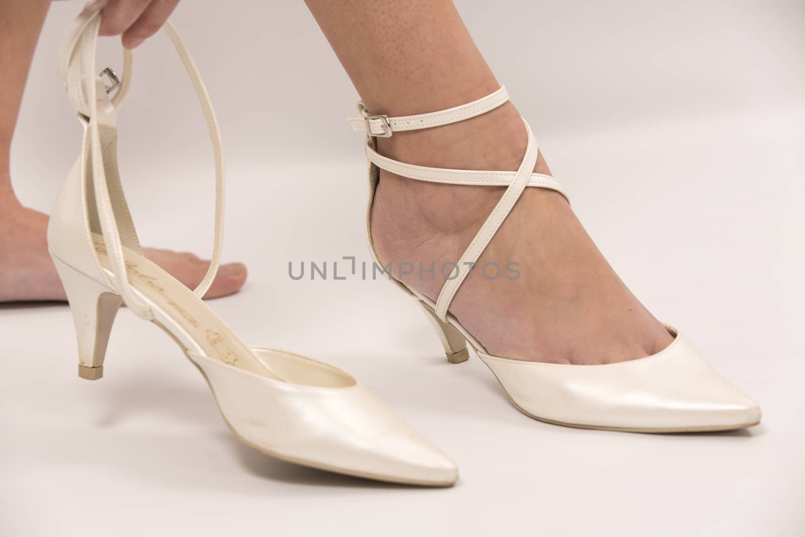 Ivory female wedding footwear over white background