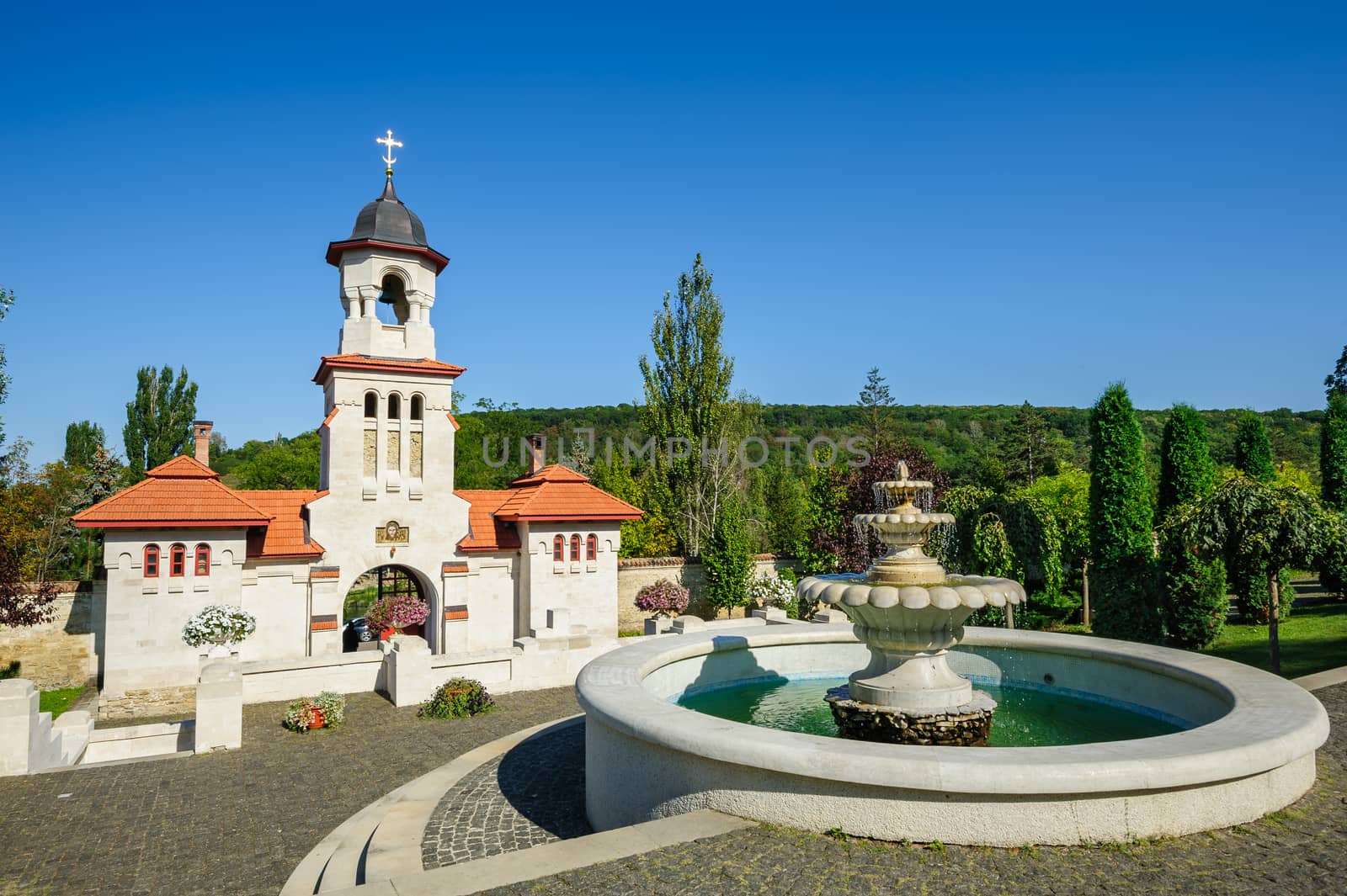 Fountain and entrance gates with bell tower, at Curchi Orthodox Christian Monastery, Moldova