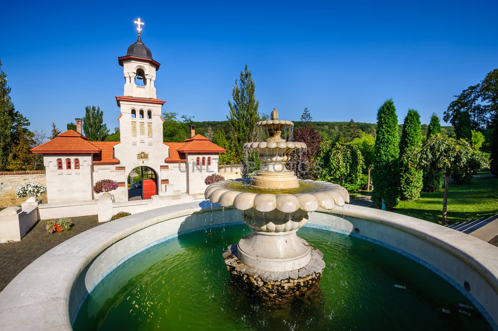 Fountain and entrance gates with bell tower, at Curchi Orthodox Christian Monastery, Moldova