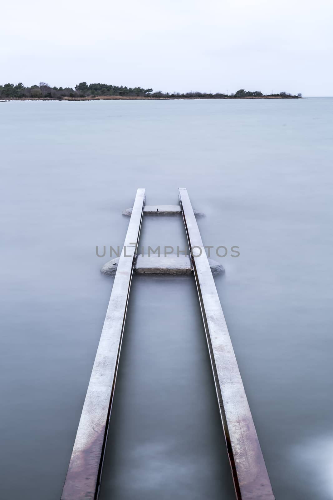 Steel Structure in Water with a cloudy sky.