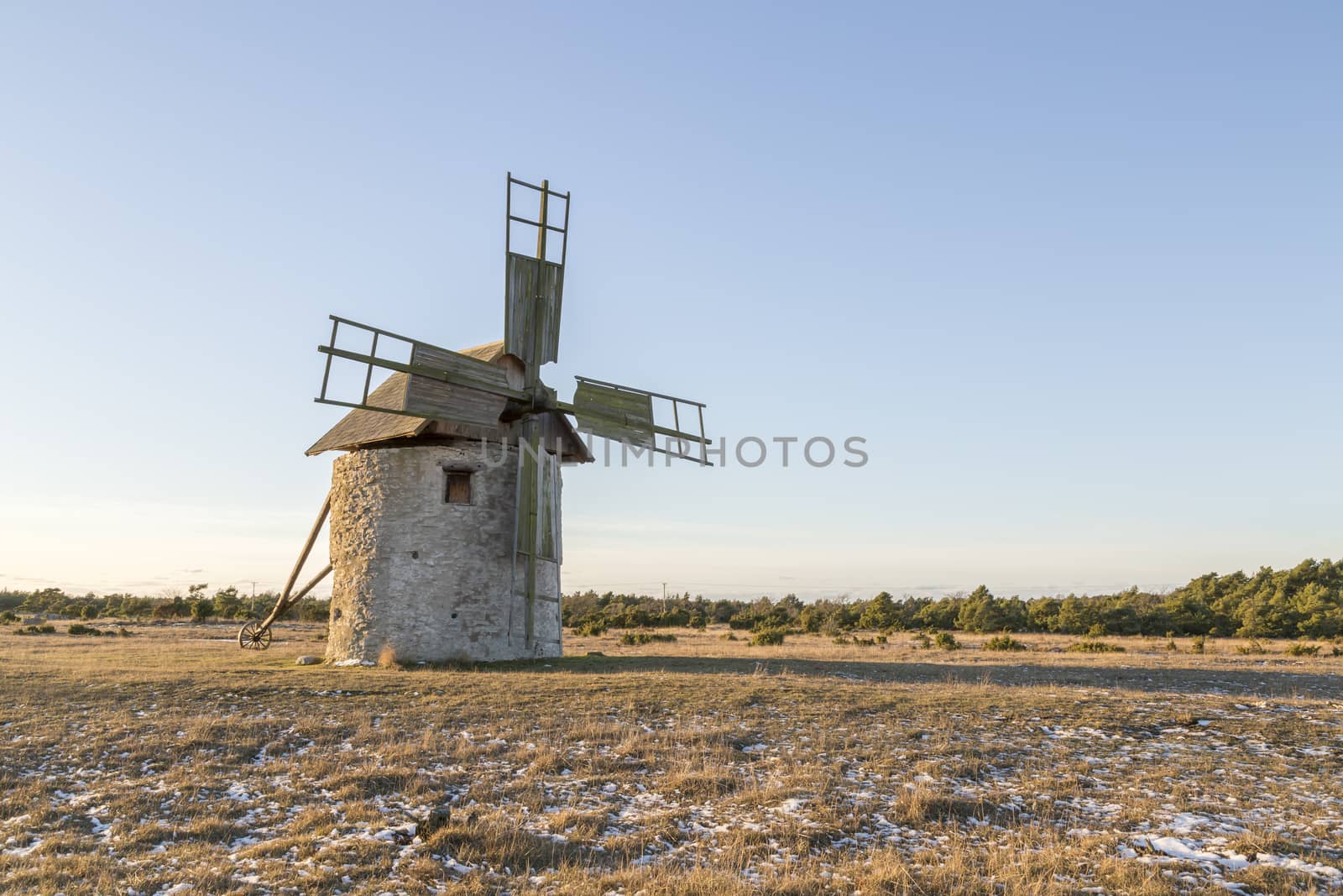 Windmill in Field with grass and snow.