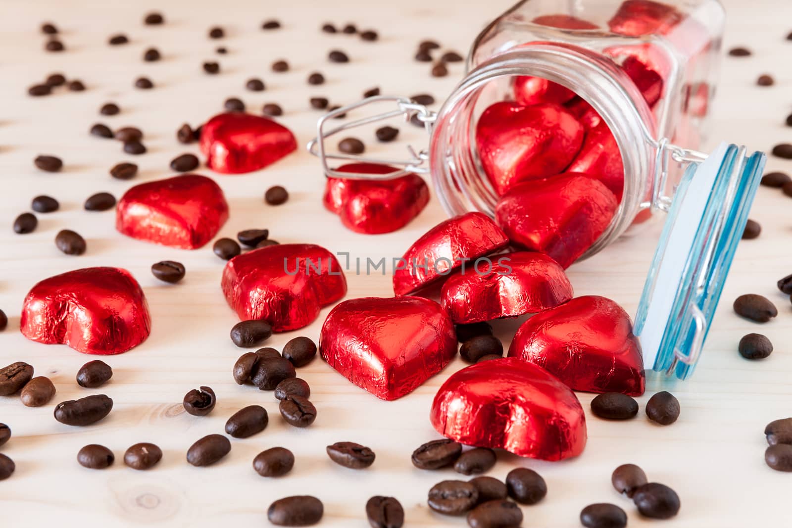 Red hearts in a glass jar and coffee beans by LuigiMorbidelli