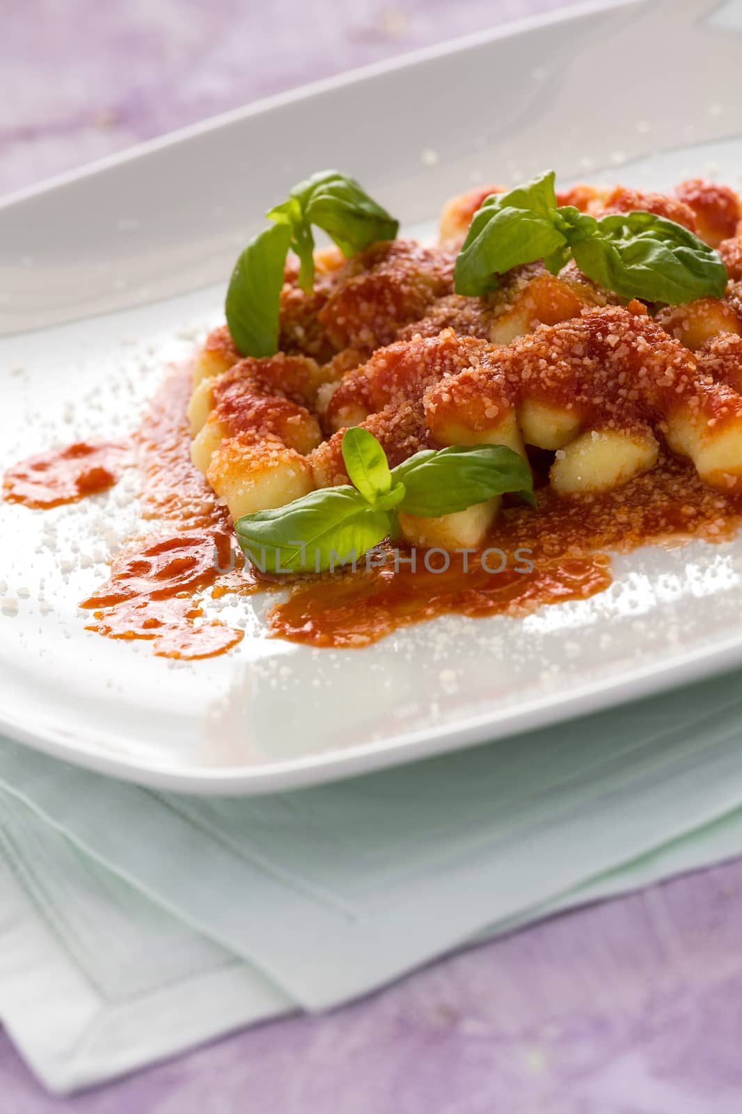 Gnocchi, Italian pasta with tomato sauce basil and grana cheese by LuigiMorbidelli