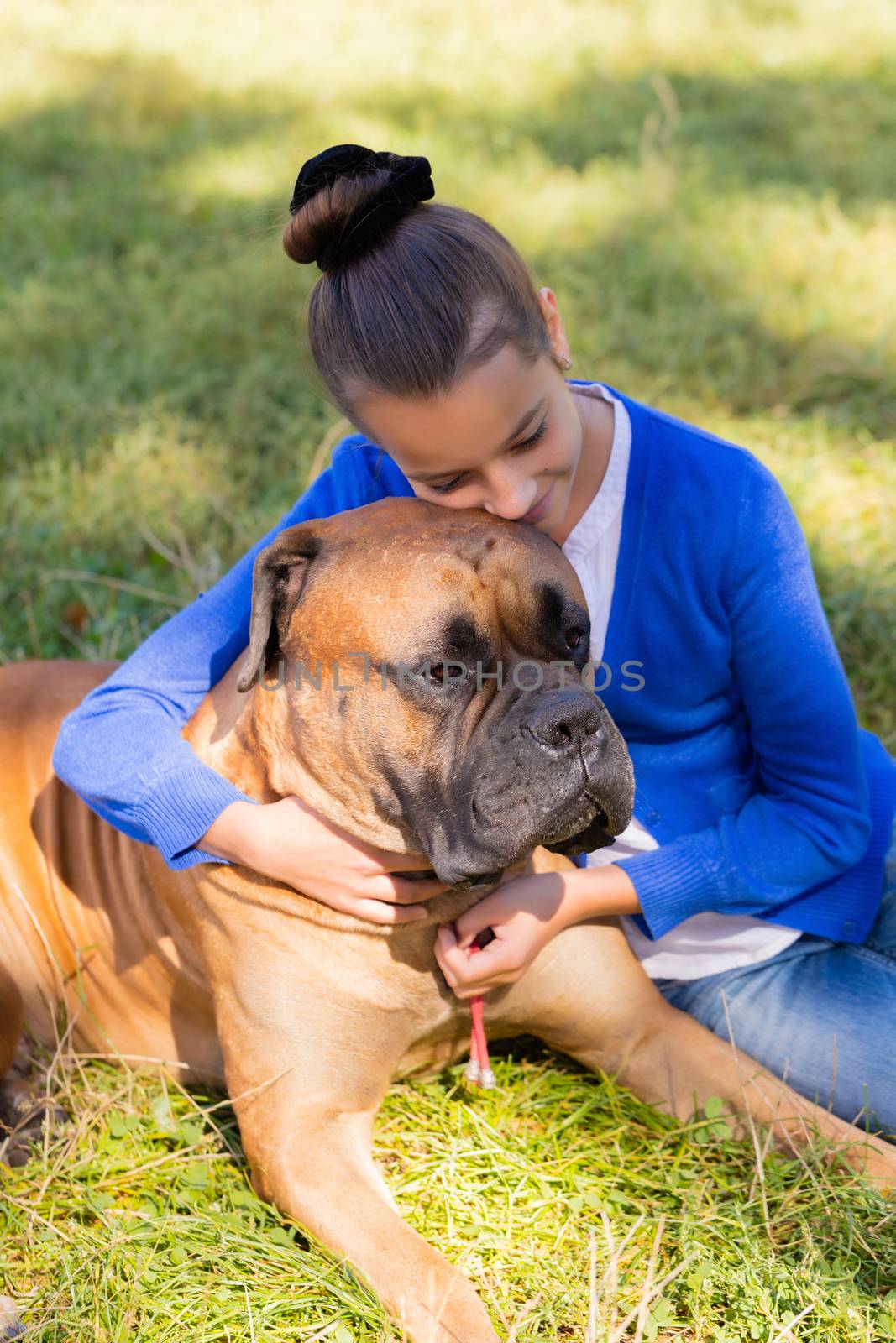 teen girl with the dog Bullmastiff outdoors