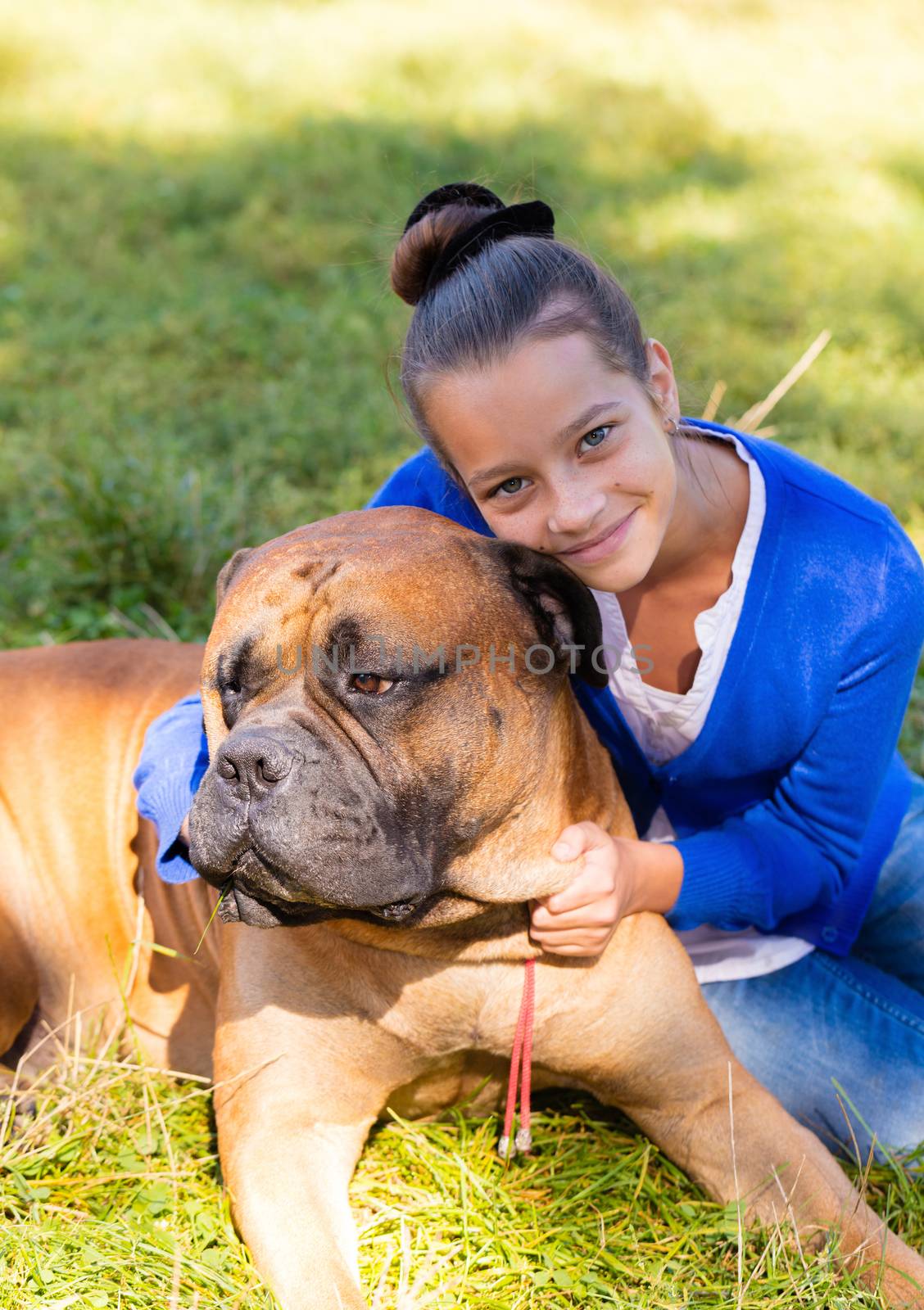 teen girl with the dog Bullmastiff outdoors