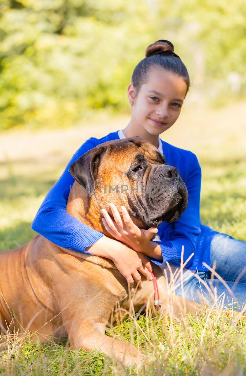 teen girl with the dog Bullmastiff outdoors