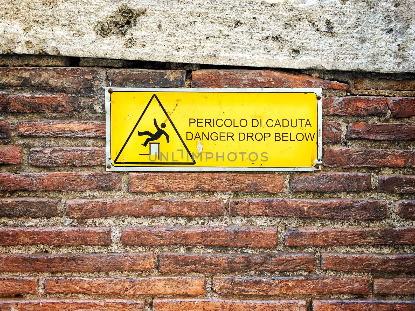 danger sign on a rough brick wall 