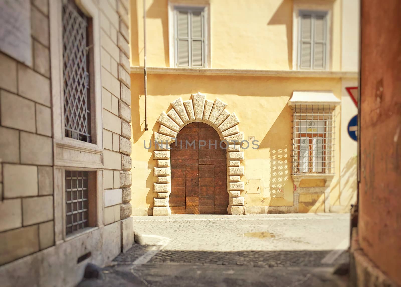 Elegant doorway of a roman building with grated windows