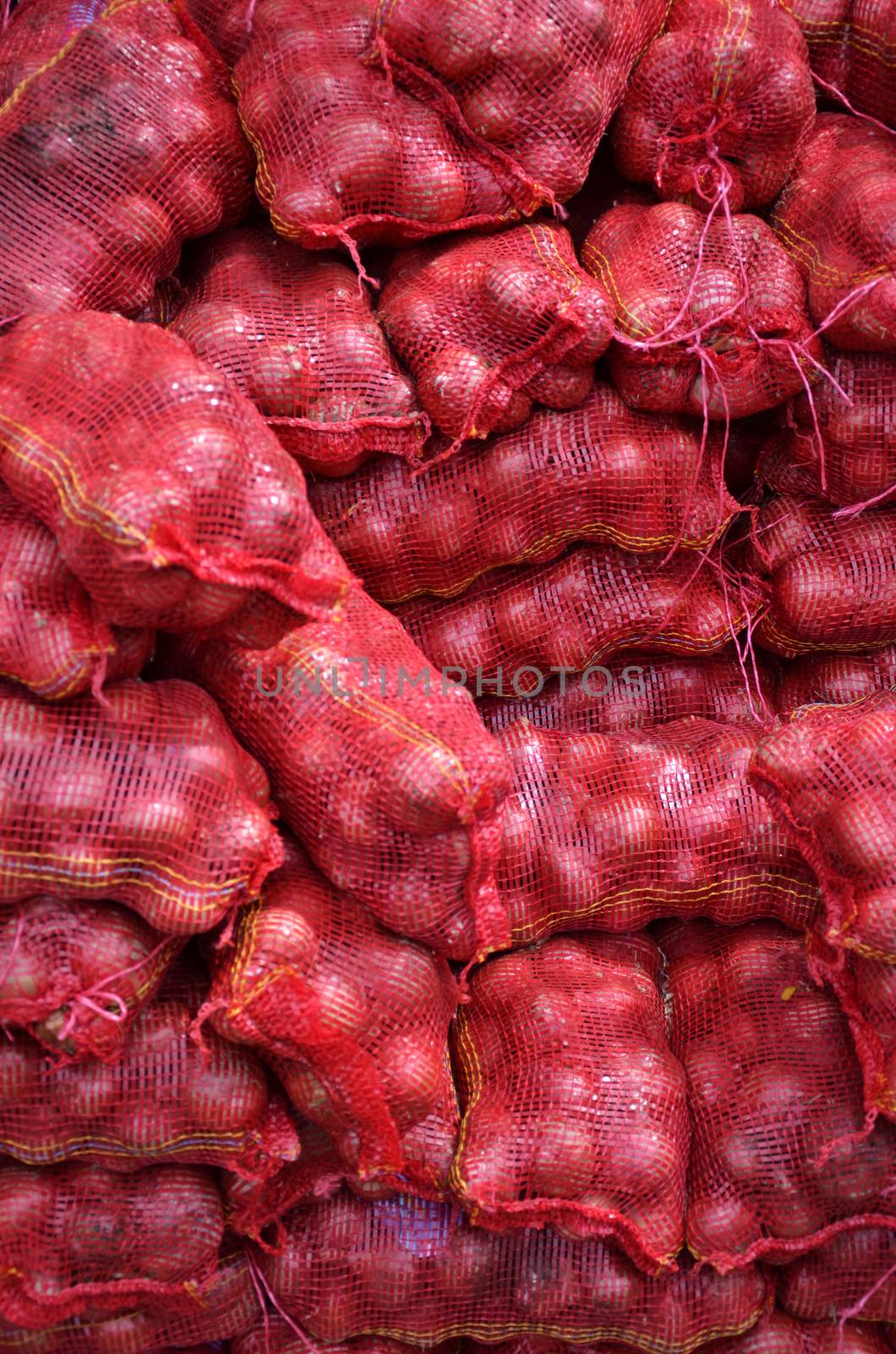 Sacs containing Large onion stacked for sale at Local Market at Little India, Singapore