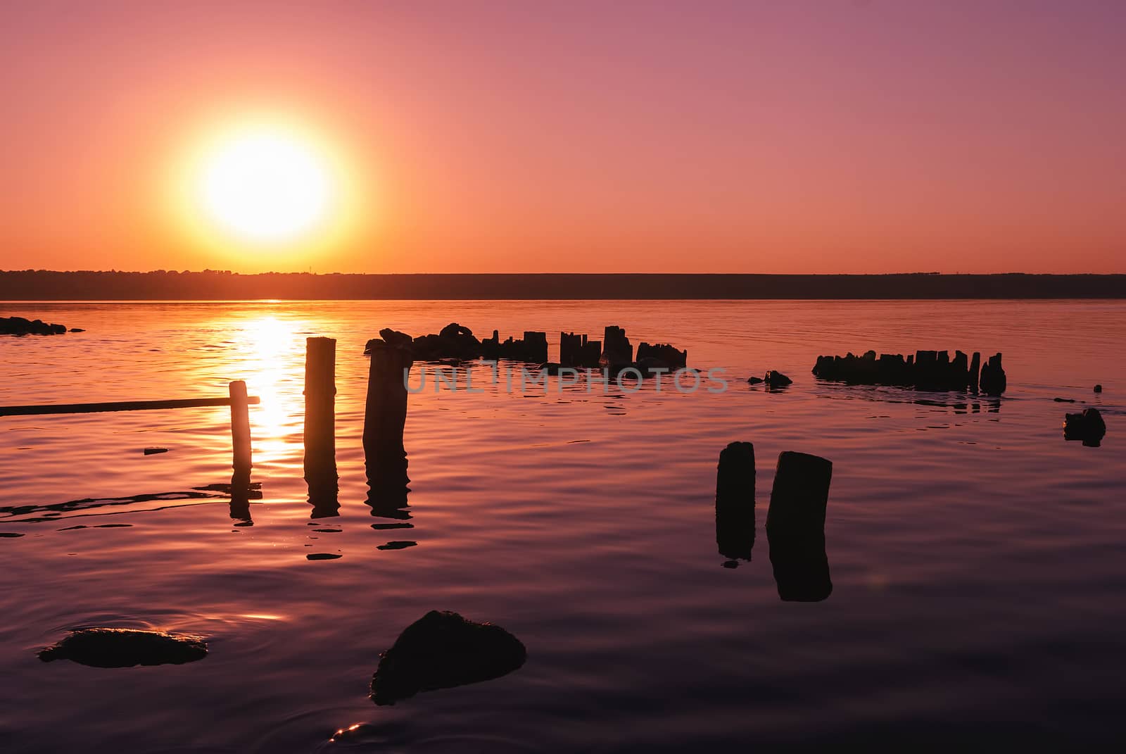 Colorful bright orange red summer sunset over lake