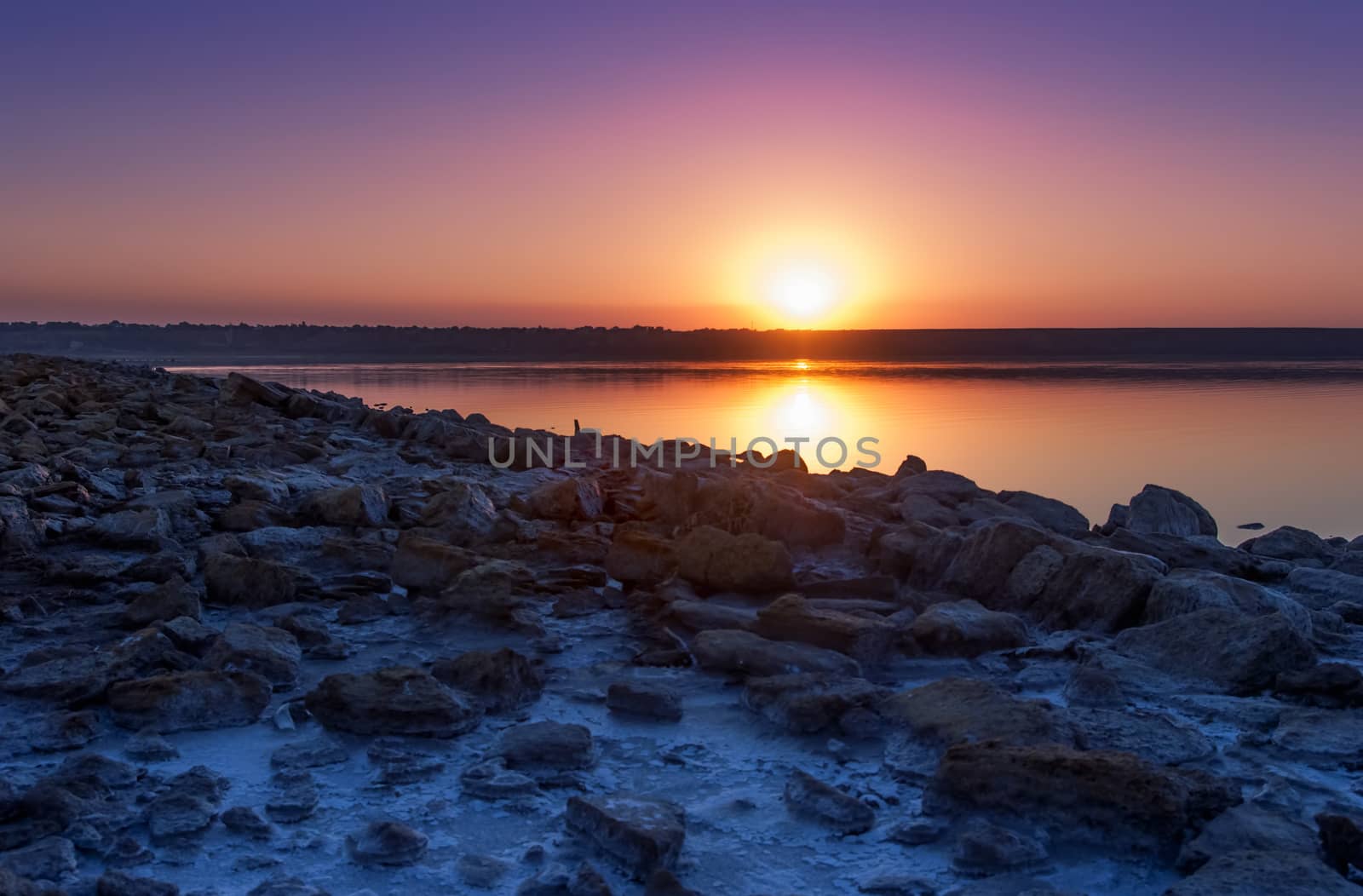 Colorful bright orange blue summer sunset over lake