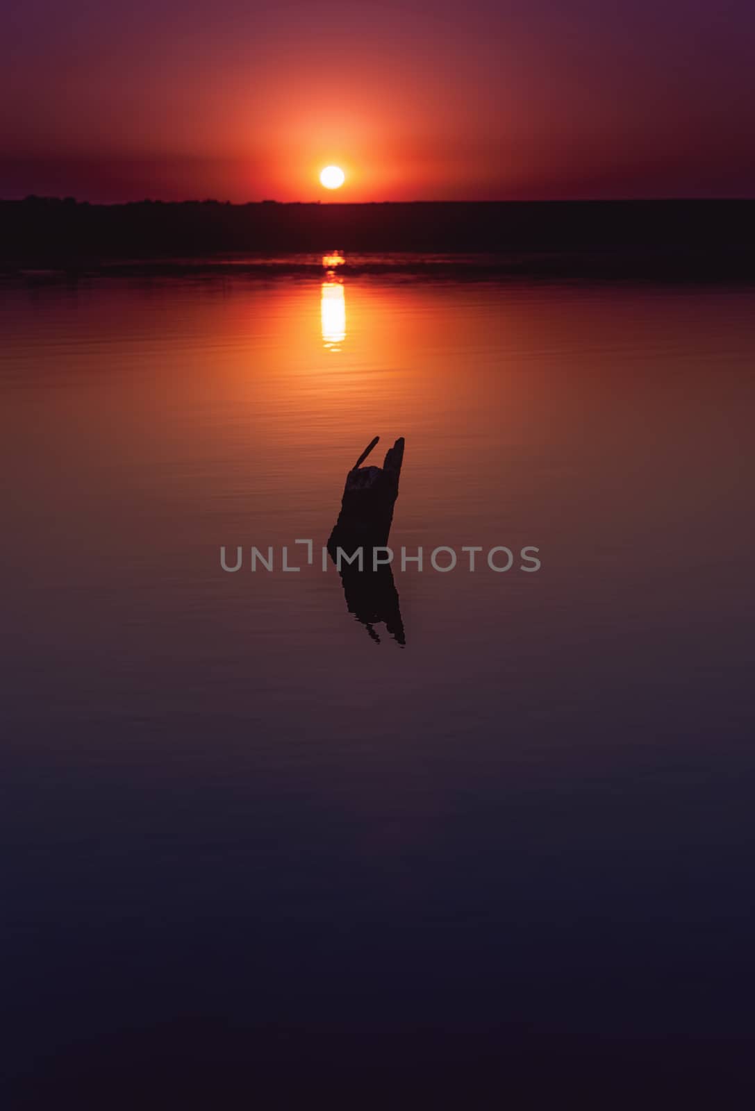 Colorful bright orange red summer sunset over lake