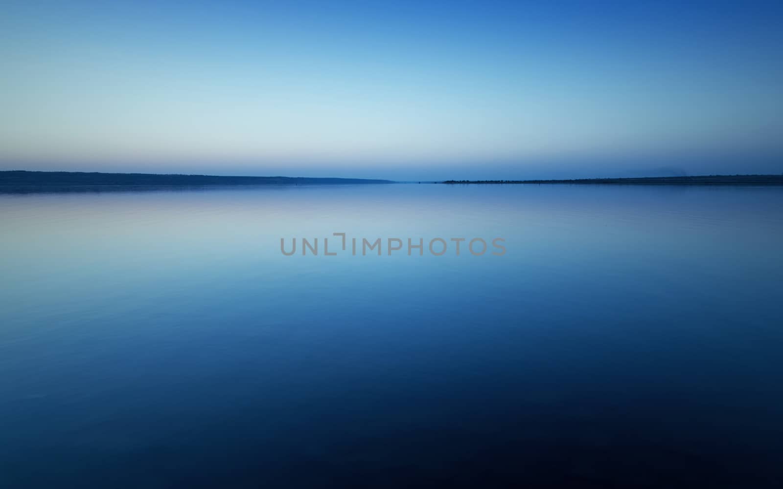 Colorful bright blue summer sunset over lake