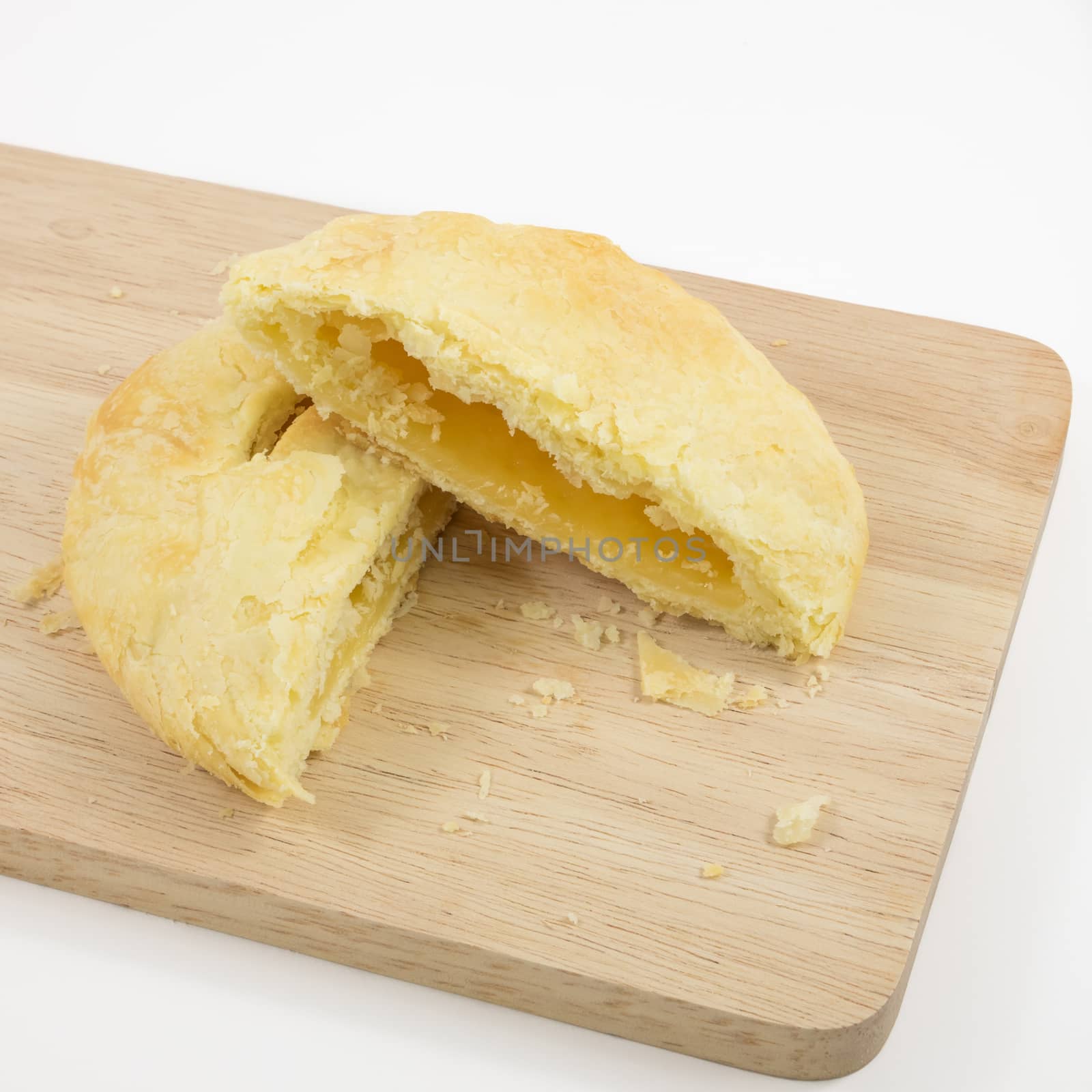 The Taiwanese sun cake (milk butter pastry) on the brown wooden plank.