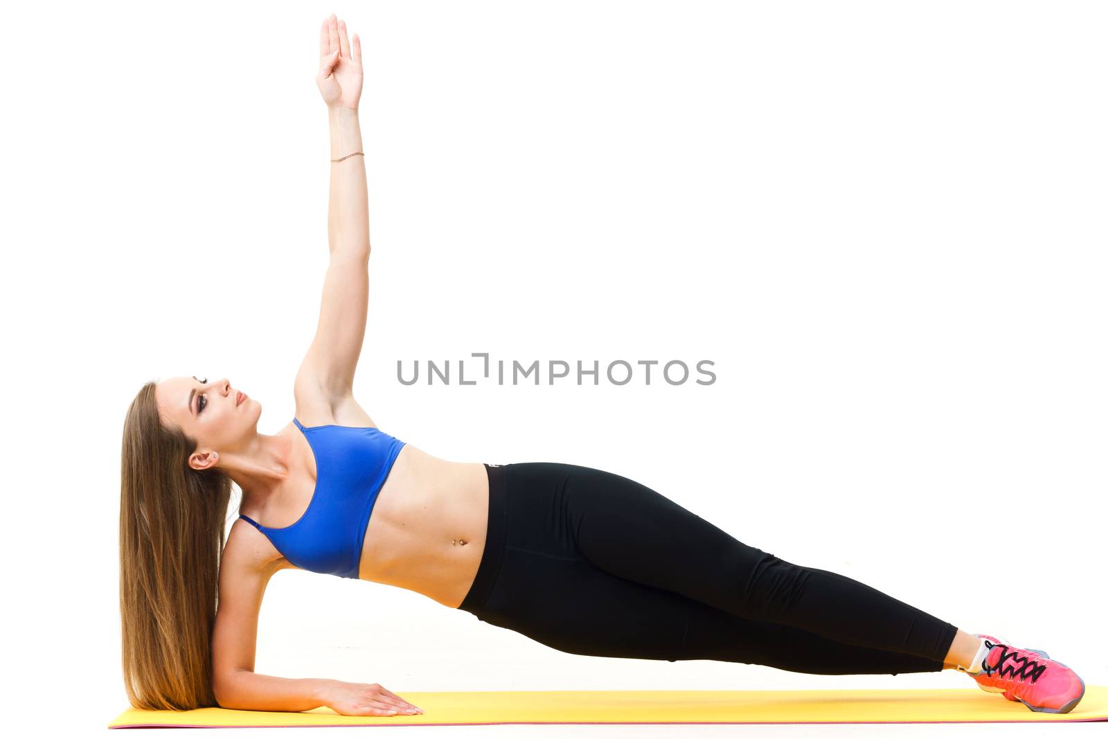 Beautiful trainer working out with yoga mat isolated on white by mrakor