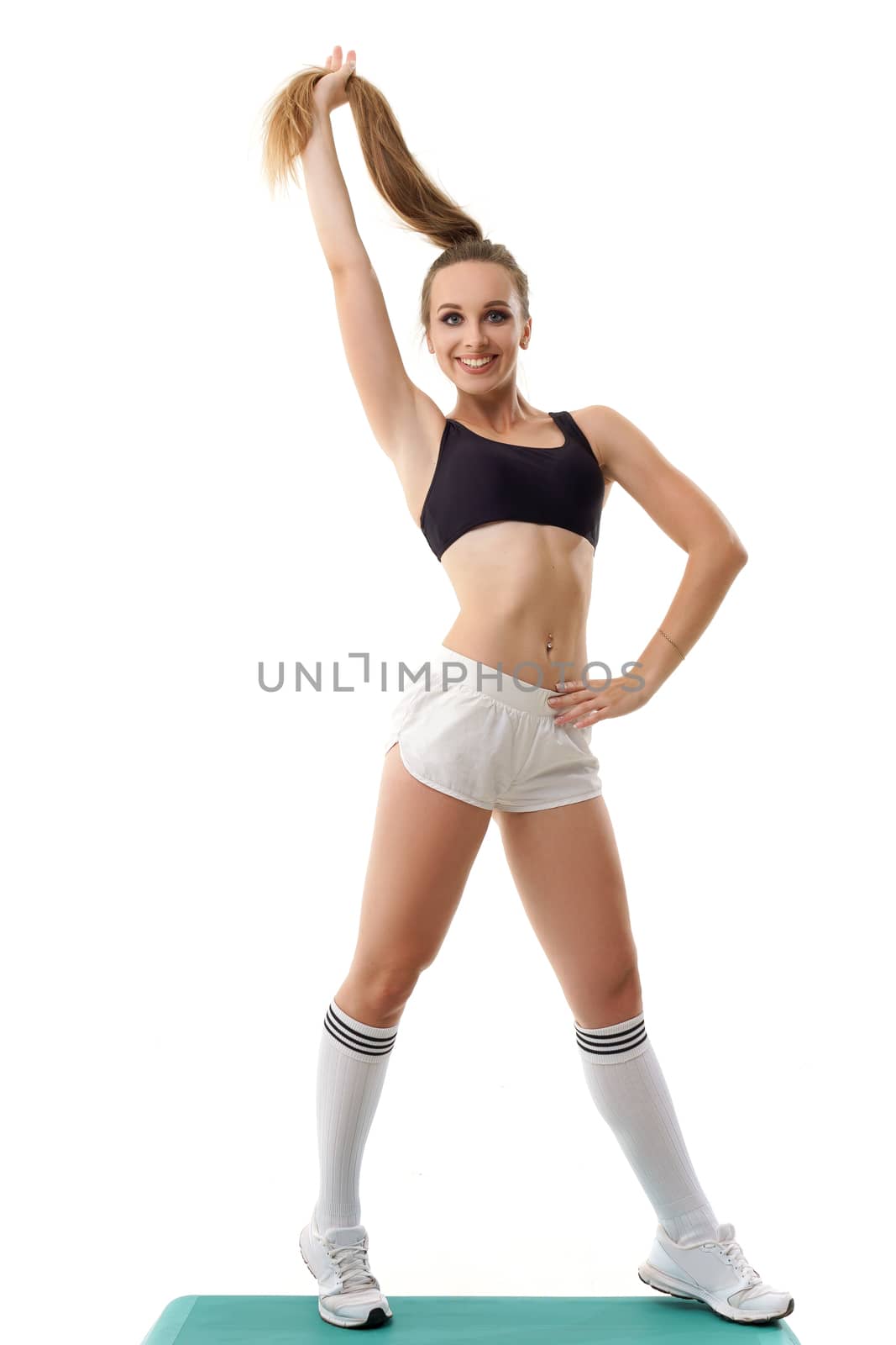 Beautiful woman trainer working out step aerobics isolated on white by mrakor