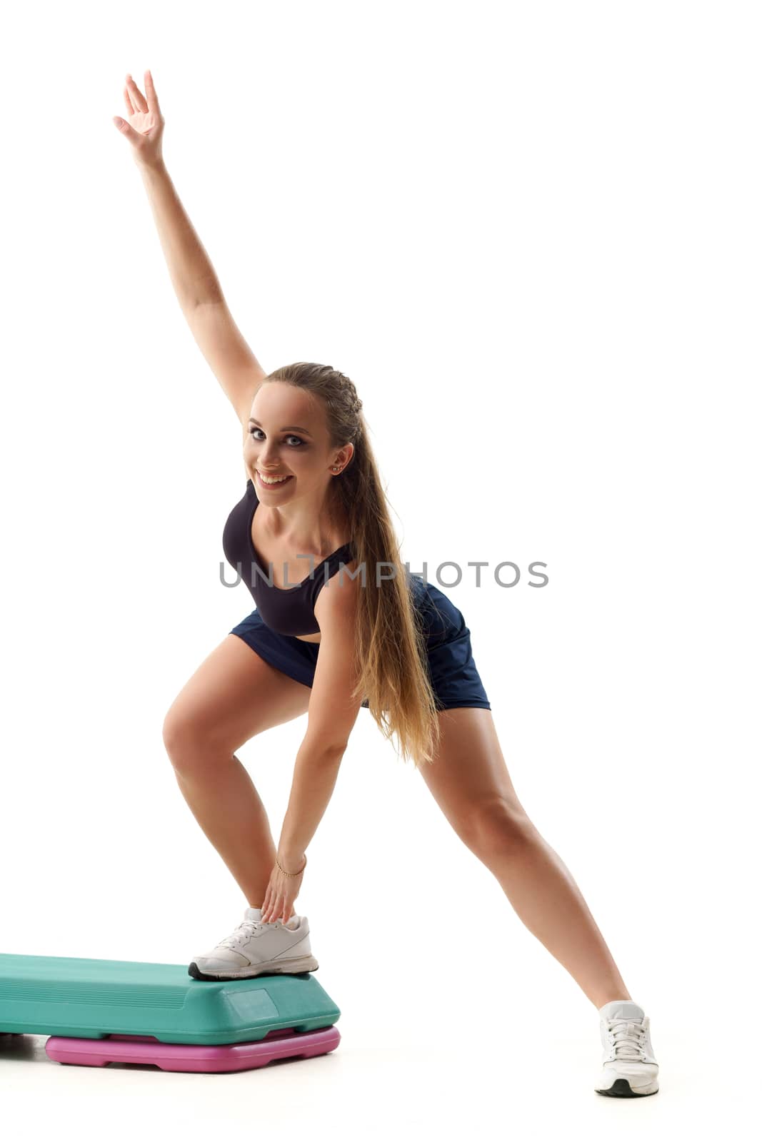 Beautiful woman trainer working out step aerobics isolated on white by mrakor