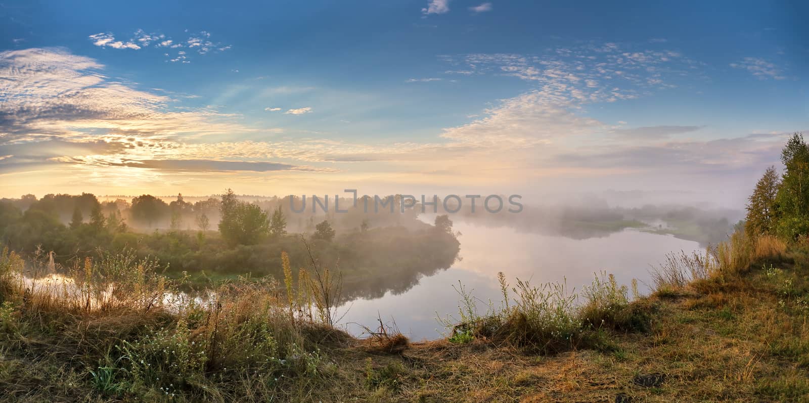 Foggy river in the autumn morning. Panorama