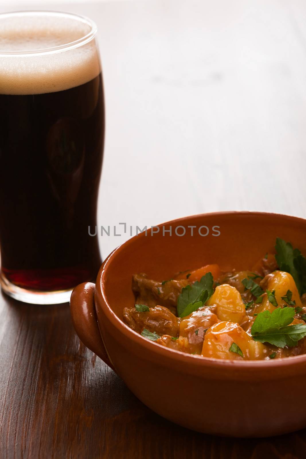 Traditional Irish Stew and a pint of beer in backlit by LuigiMorbidelli