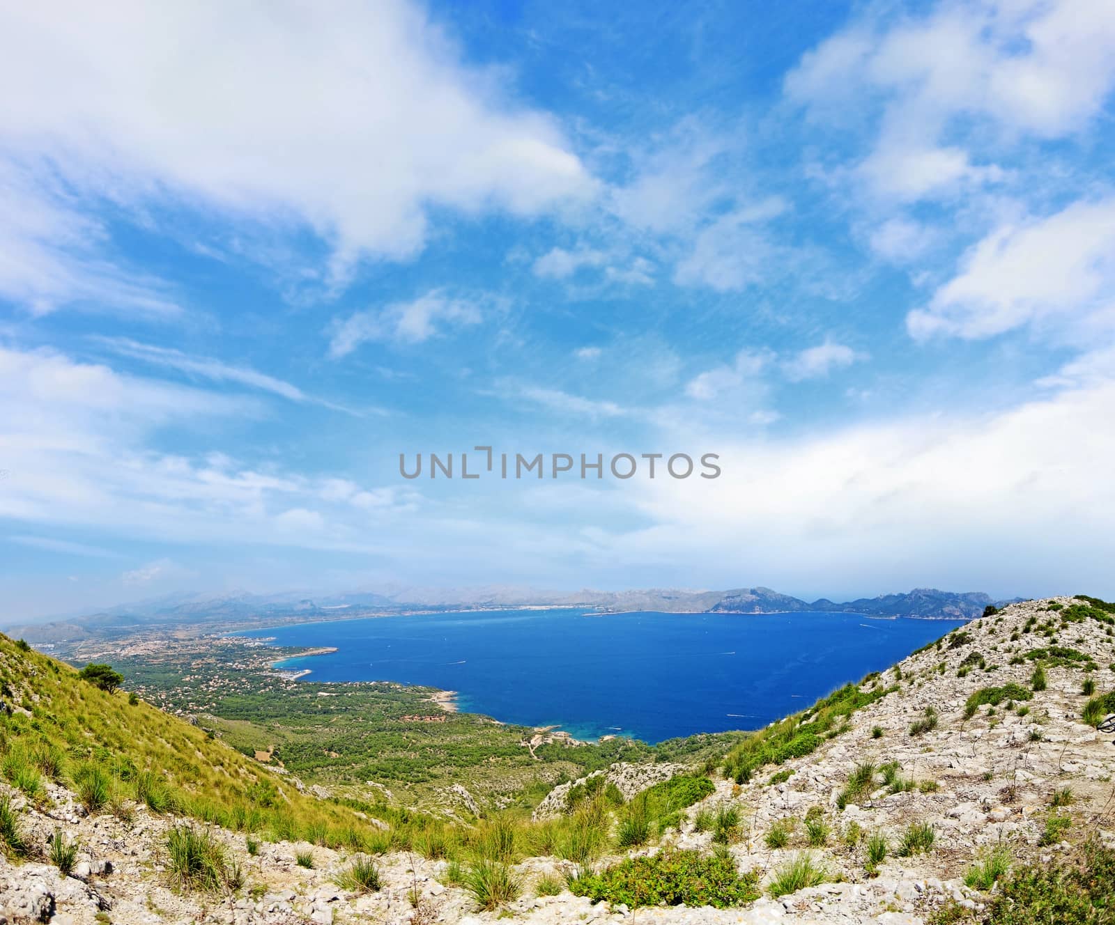 Bay / coast panorama with cloudy sky - mountains in front - north of majorca, spain