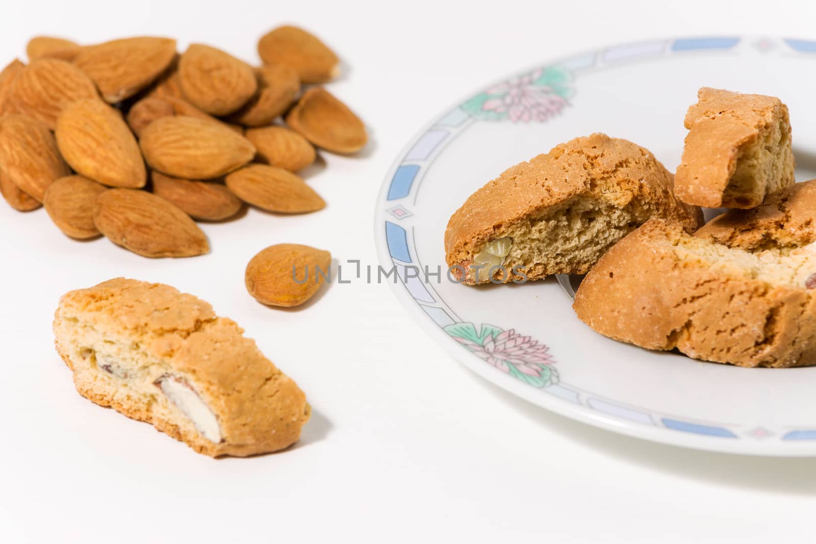 Cantuccini, original Italian almond cookies on a plate on white background
