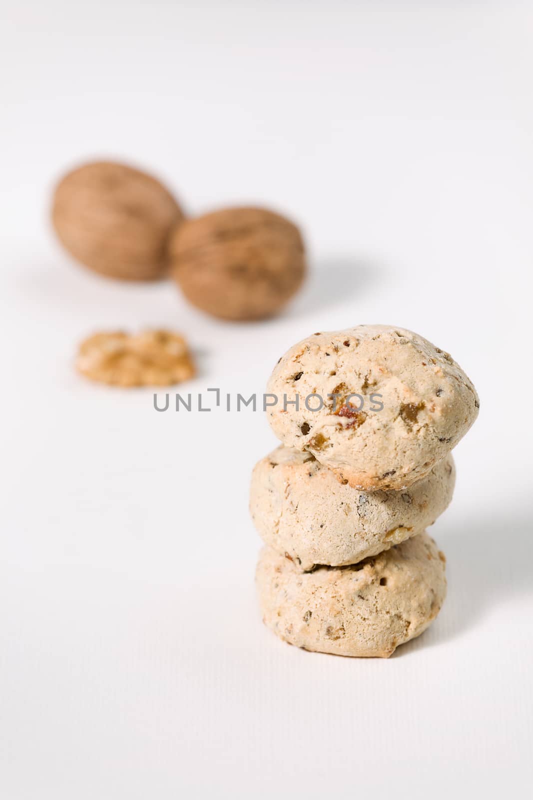 Cavallucci, typical Italian cookies with walnut and candied fruit on a white background