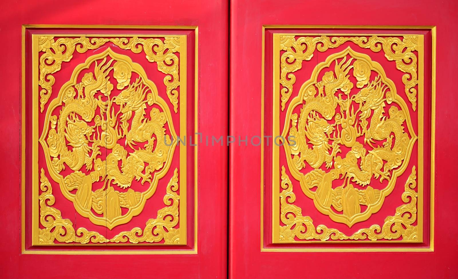 Golden dragon on the red door of Chinese temple in Thailand