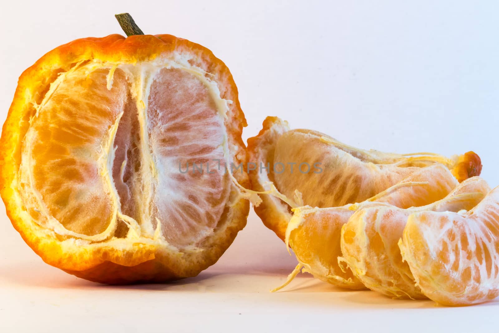 peeled tangerine on white background. Ideal for layout