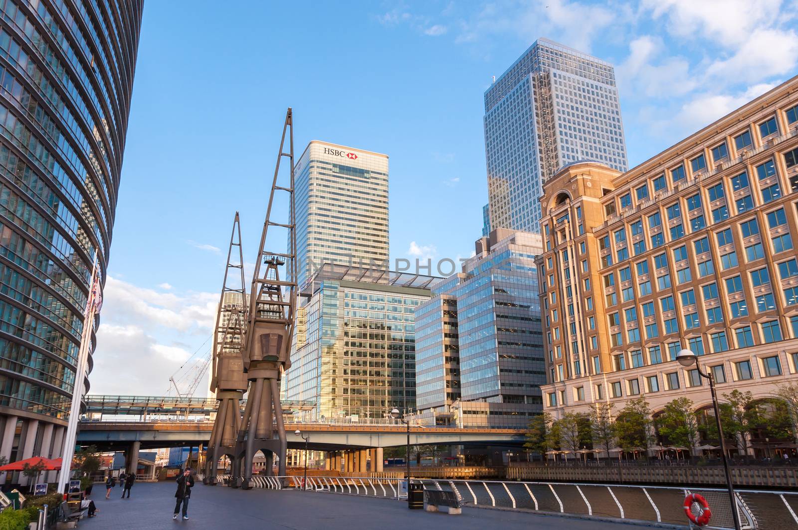 LONDON, UNITED KINGDOM - May 9: HSBC's world Head Quarters building and old port cranes part of the redevelopment around Canary Wharf in the London Docklands on May 9, 2011 in London.