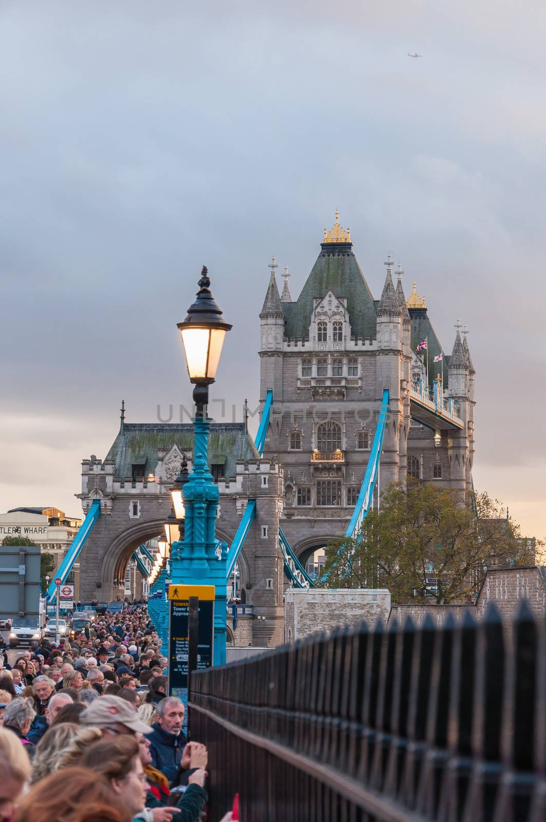 London, United Kingdom - November 7, 2014: Crowd on the street leading to Tower Bridge on Poppy Day at dusk.