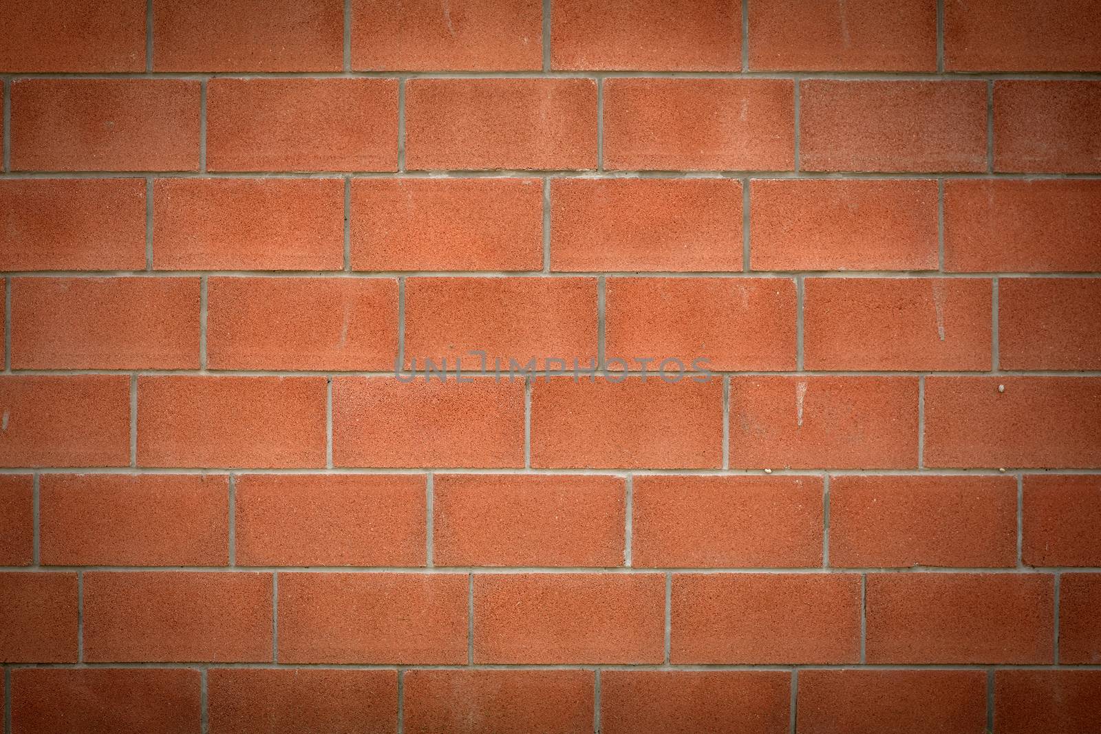 Abstract brick red wall. Vignetting at the edges