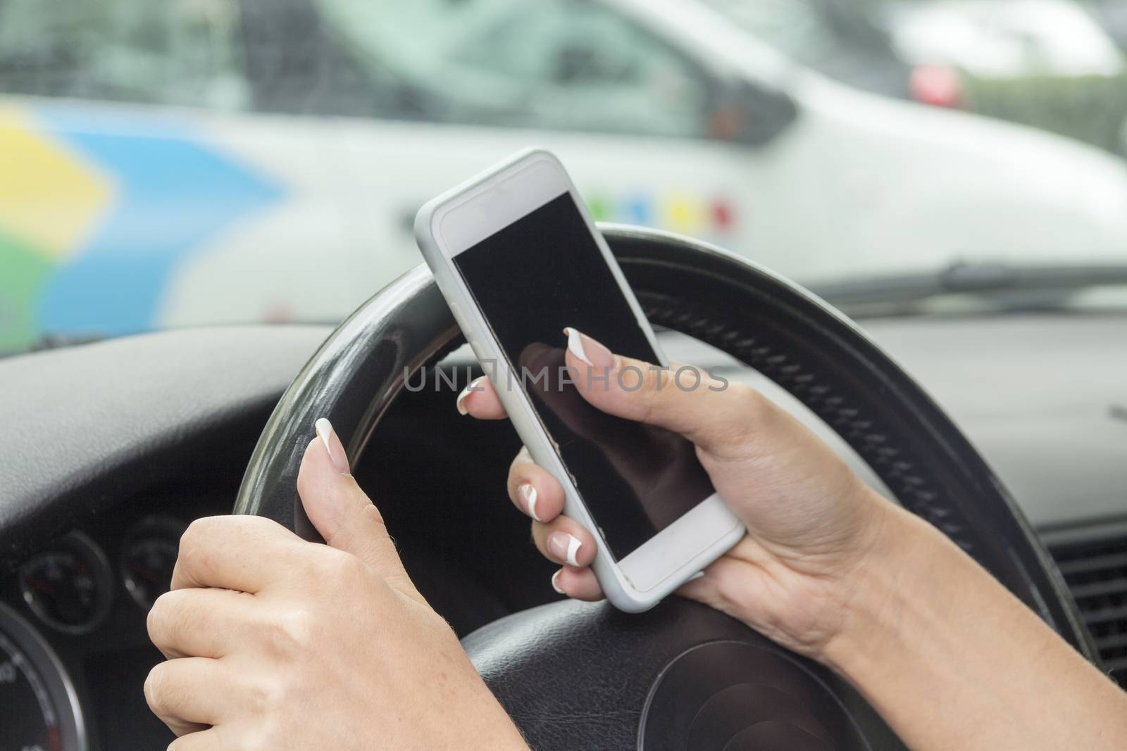 driving in a car in the hands of the girl cell phone