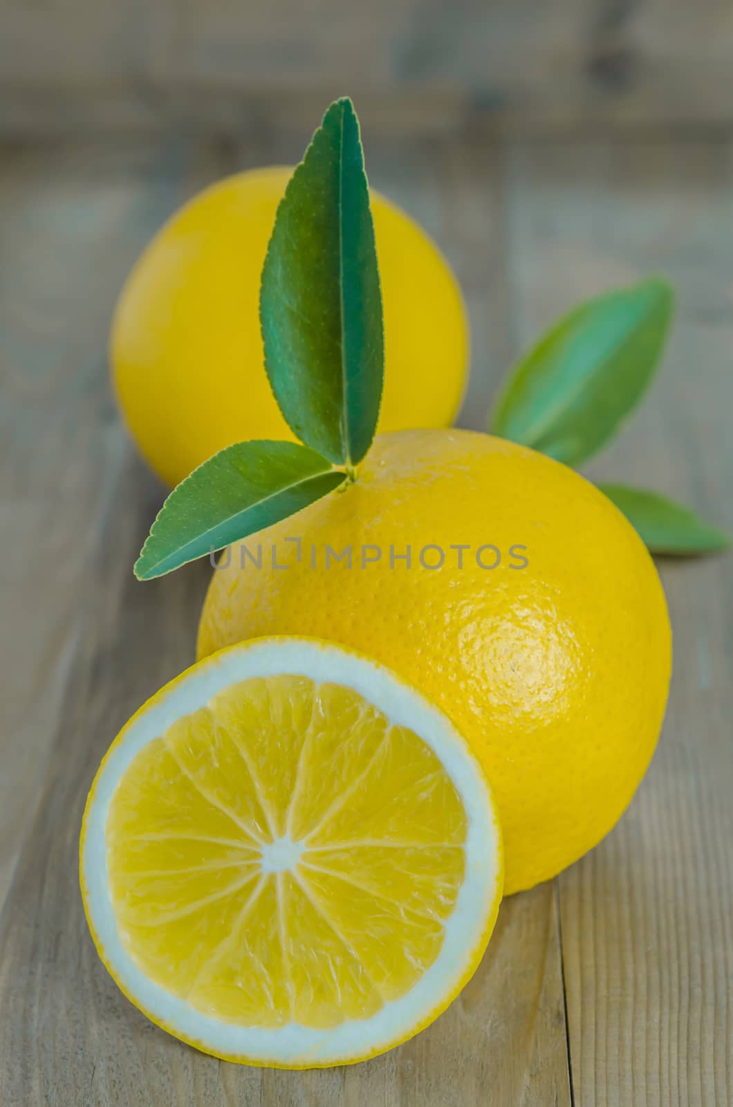 ripe orange with leaves on wooden background